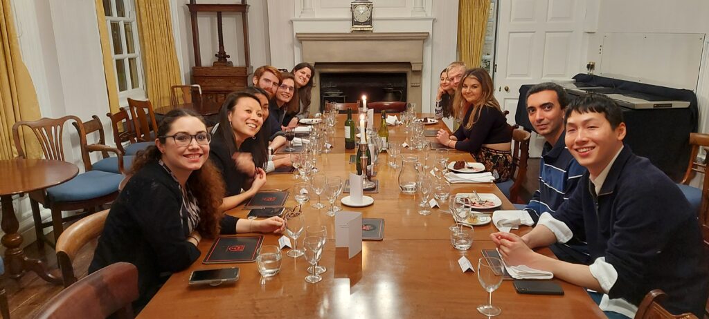 People gathered around a table with plates and glasses for dinner.