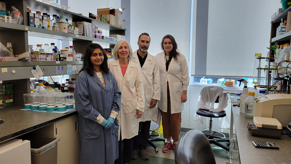 Scientists pose for a photo in a lab