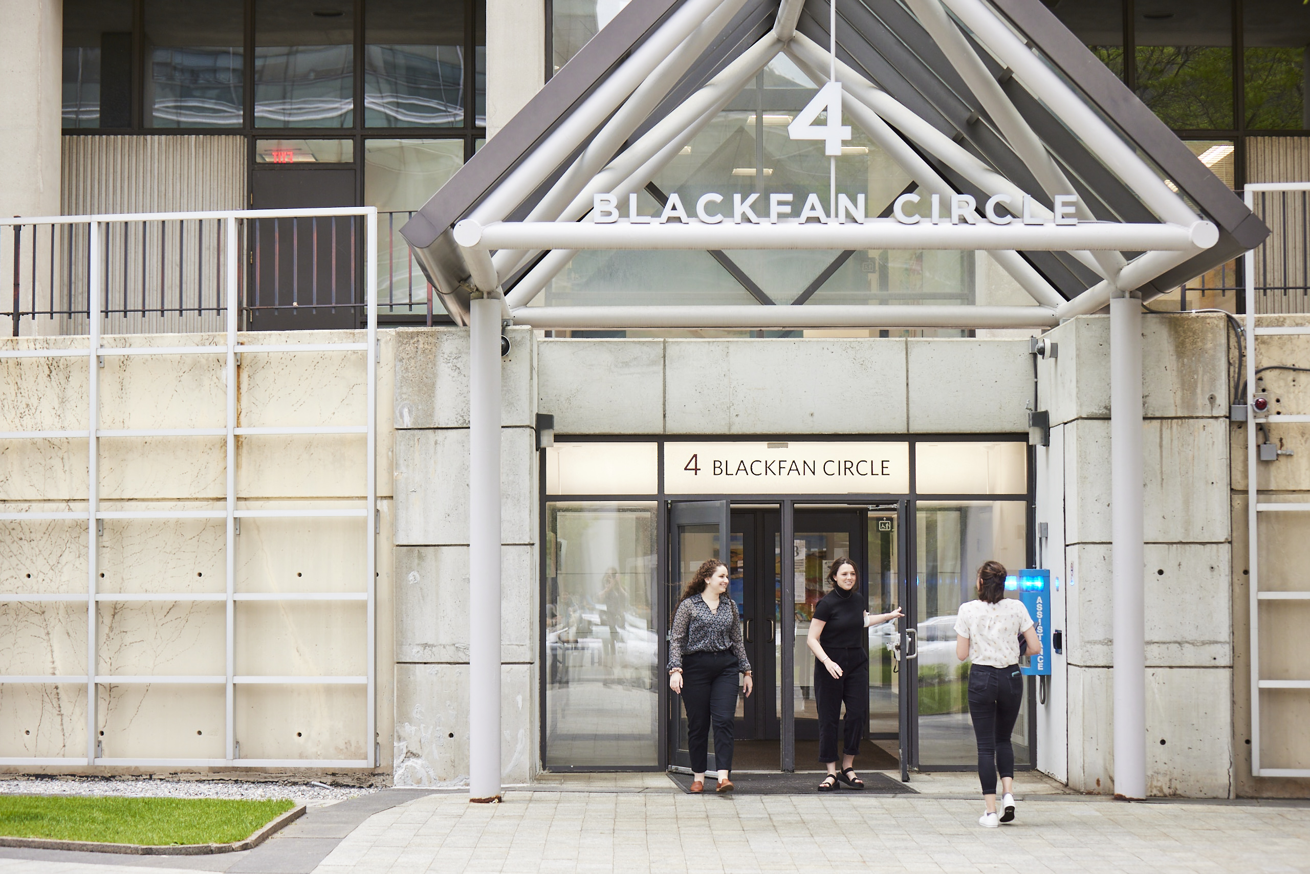 IPI employees walking through lab building doors.