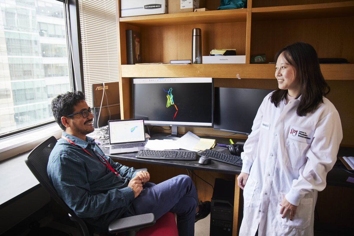 A man and a woman in front of a computer