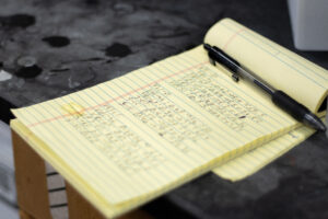 Lab notes with pen on lab bench.