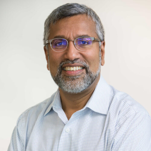 Formal headshot of Auro Nair in front of a white background.