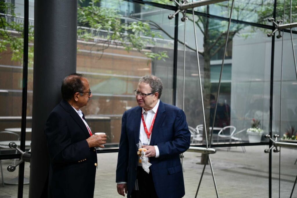 Two men talking in office building.