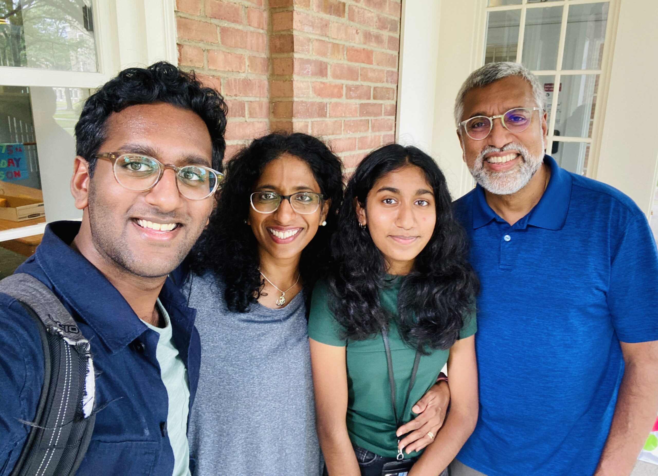 Auro Nair and his family crowd into a photo, all smiles.