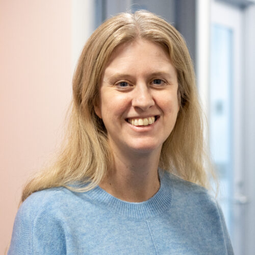 Woman smiles in office.