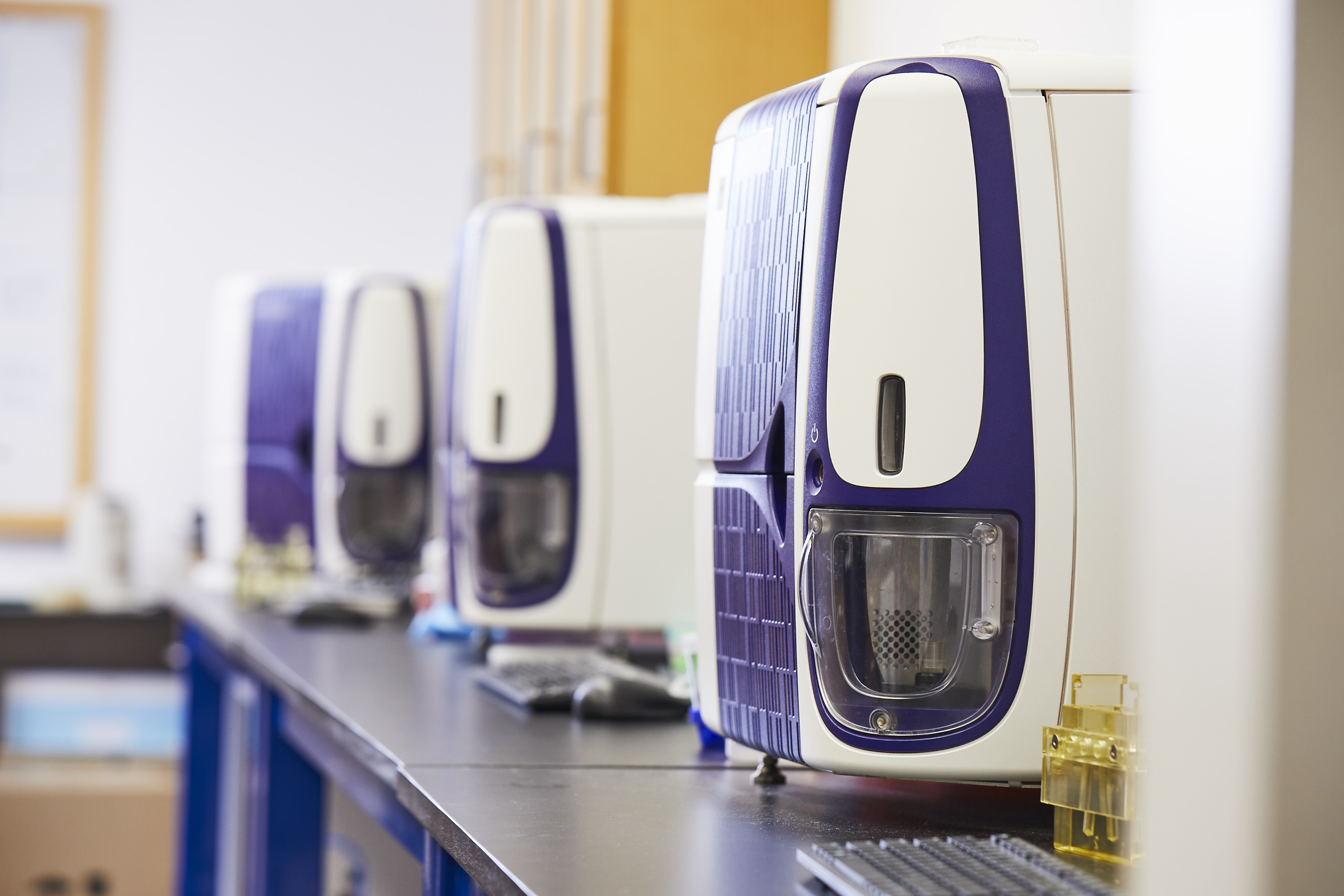 Three FACSMelody Cell Sorters sit on tables at IPI, for use in antibody discovery.