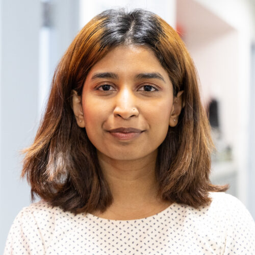 Maisha Chowdhury smiles for headshot in IPI office.