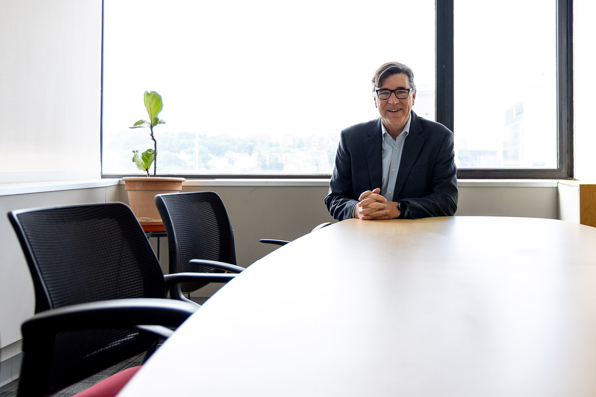 Kevin Harvey sits at the head of a table in the IPI office.